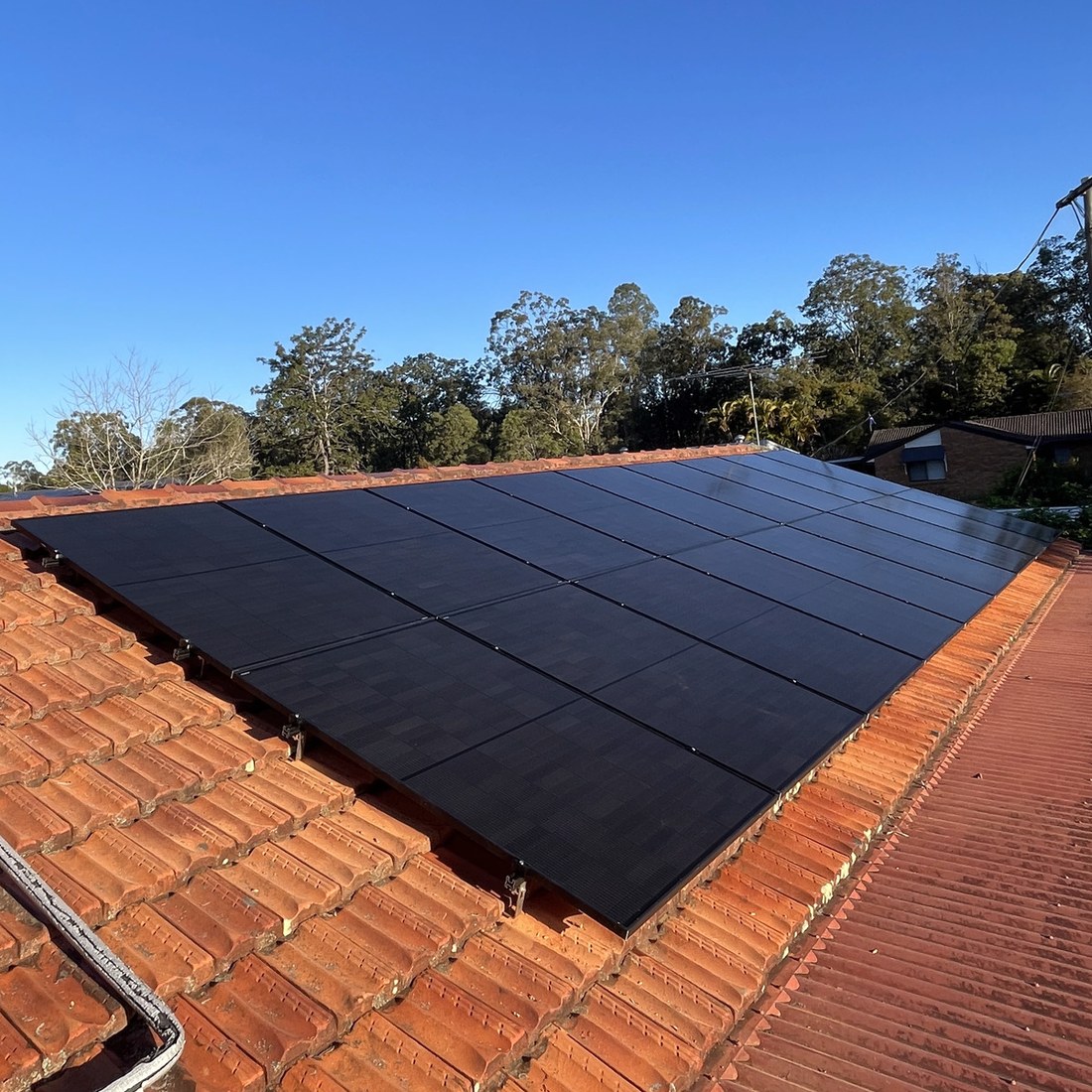 All-black array on a terracotta tile roof